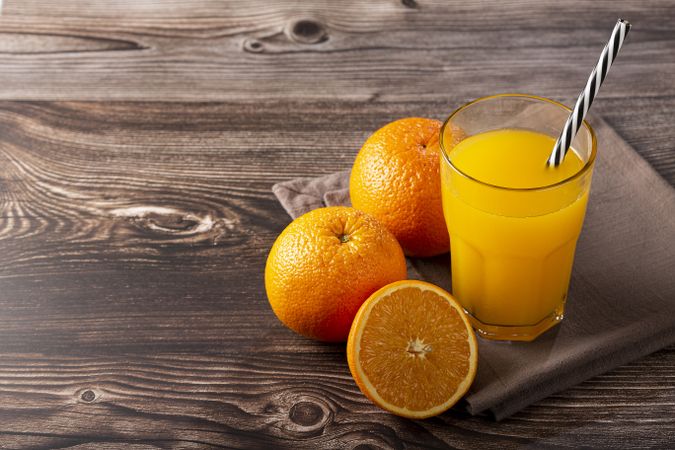 Glass with orange juice on the table.