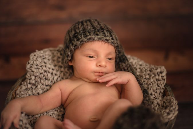 Naked baby in bucket