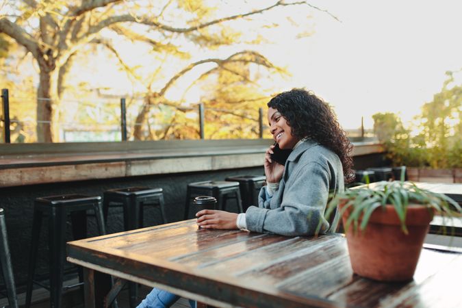 Woman sitting outdoors at a coffee shop