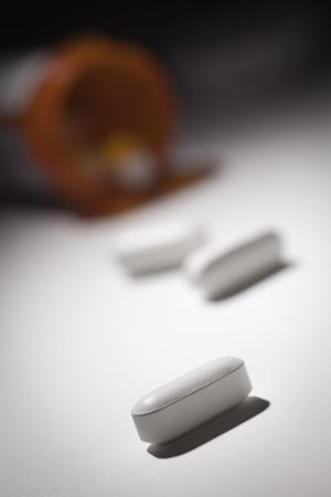 Medicine Bottle and Pills Under Spot Light