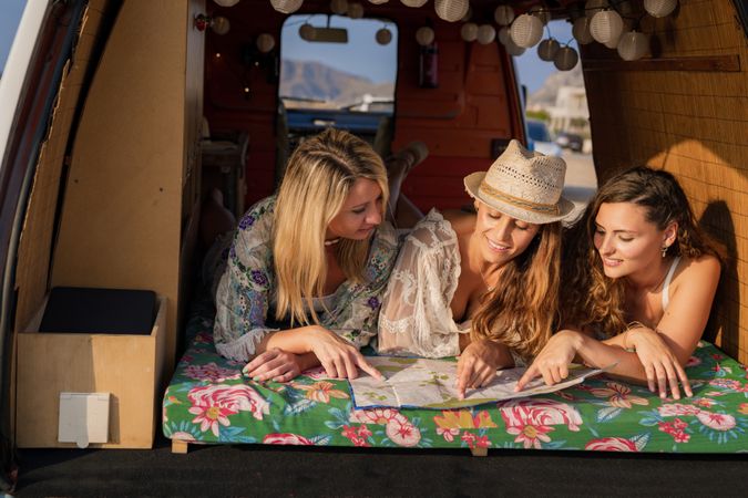women looking at a map inside a minivan