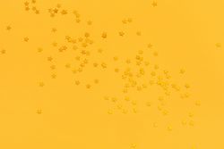 Golden stars on vibrant yellow background