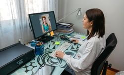 Woman talking on video call with her doctor