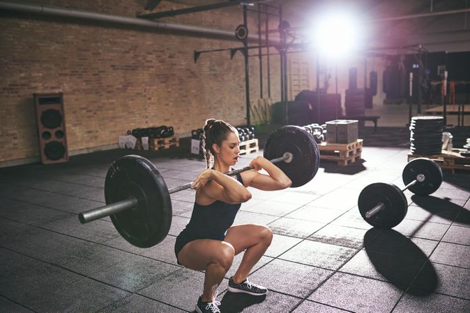 Female doing crossfit exercise using barbell