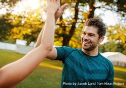Outdoor shot of young man giving high five to a woman 482870