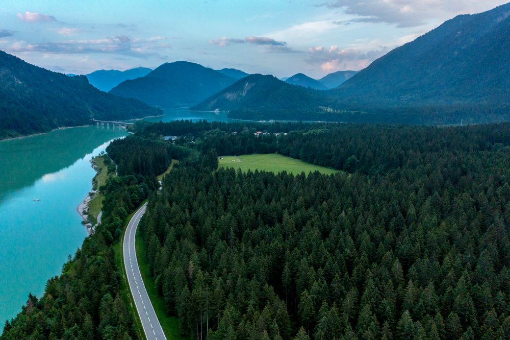 Drone aerial view with forest and Sylvenstein Lake in the Bavarian Alps, Germany
