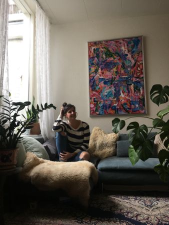 Woman sitting on sofa in living room