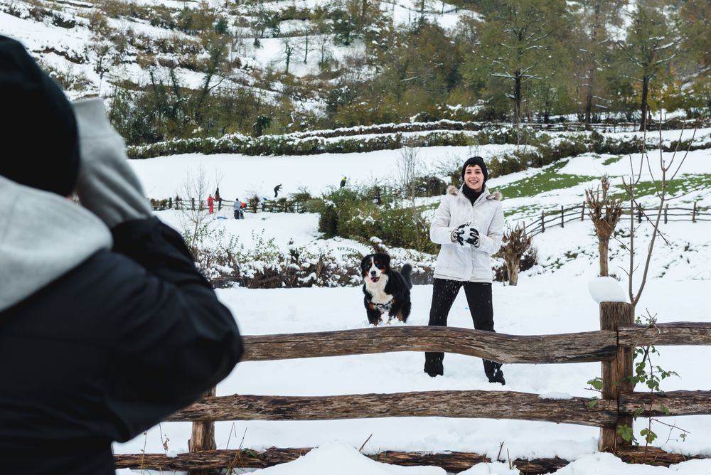 Happy woman play snowballs in countryside