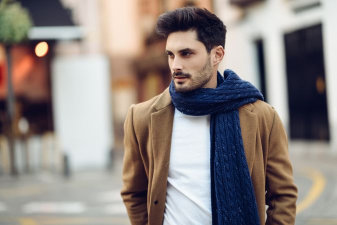 Portrait of man in light winter clothes walking outside
