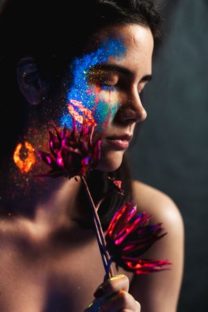 Young woman covered with uv painting