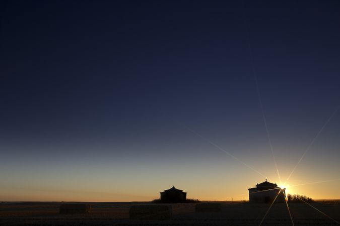 Aged house in rural countryside under starry sky