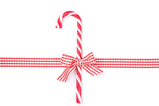Sweet candy cane with bow isolated on blank background