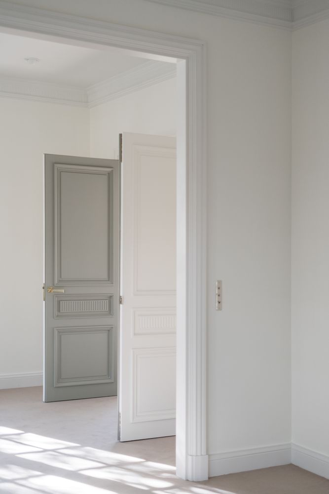 Interior of white hall with opened door