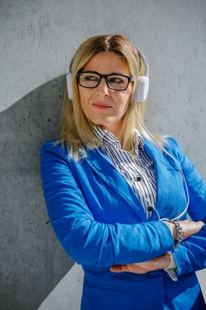 Businesswoman with headphones posing