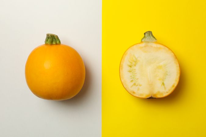 Round zucchini and half on two tone background