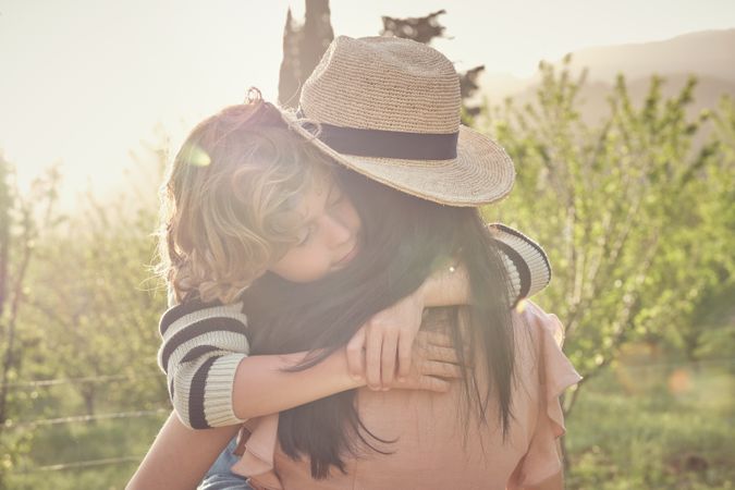 Little son with woman in field