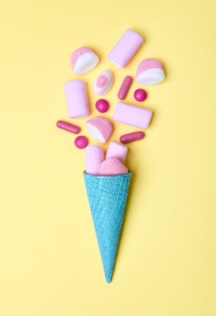 Blue waffle cone with spilled candies