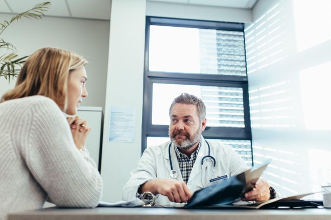 Male doctor meeting with patient in office