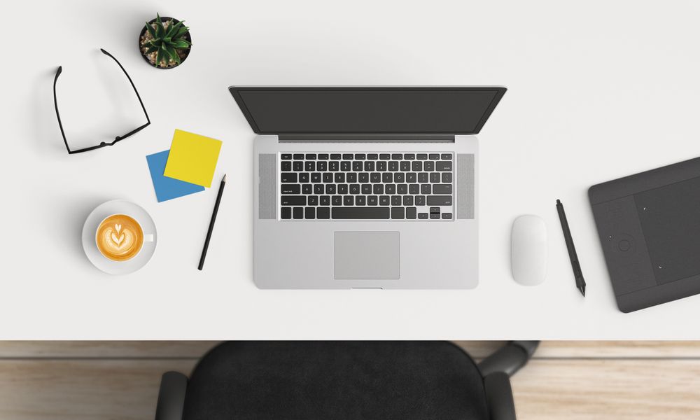 Modern workplace with laptop and smartphone copy space on table background. Top view. Flat lay style.