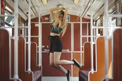 Woman jumping in train car