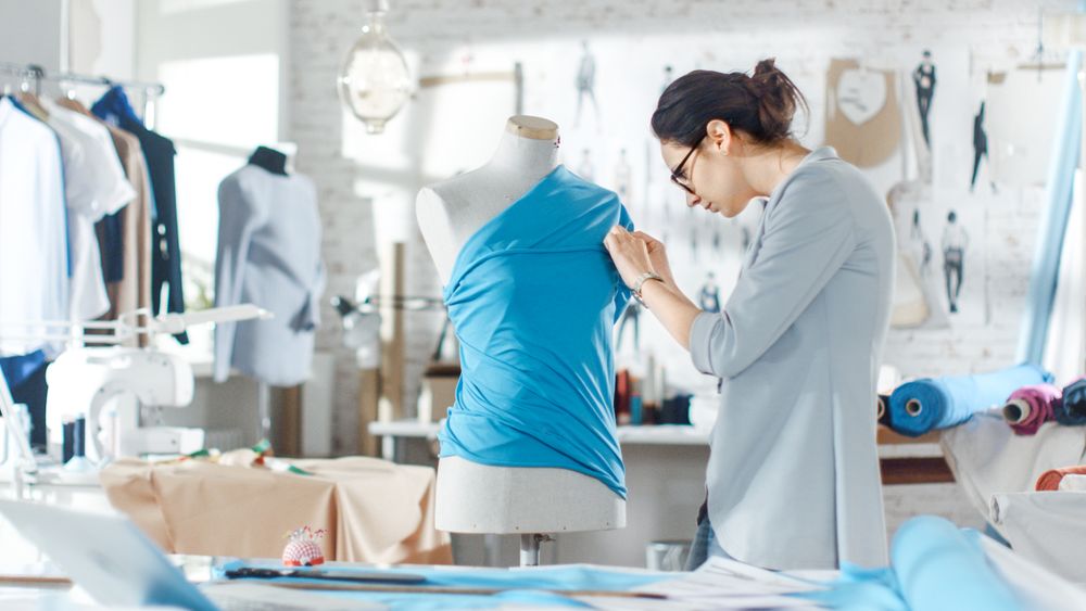 Female fashion, designer,  Adjusting Fabrics on a Tailored Mannequin.