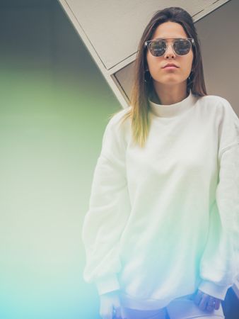 Young woman standing against wall