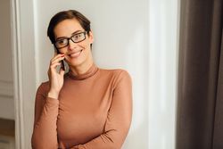 Woman smiling while on a phone call
