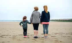 Three female generations watching the sea