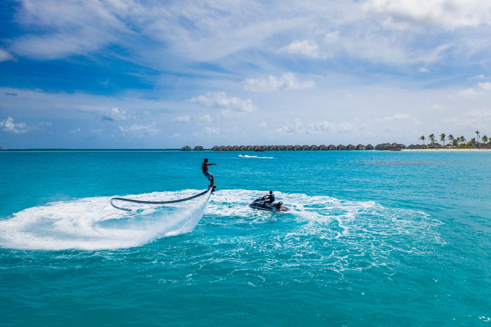 Person jet blading and another riding a jet ski