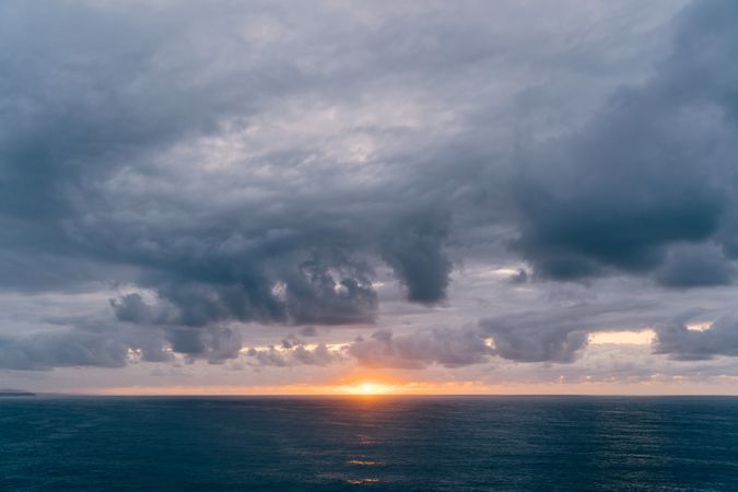Grassy shore near stormy sea in evening