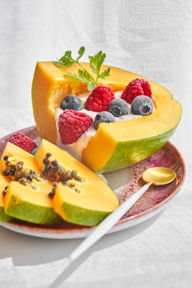 Plate with papaya bowl and berries