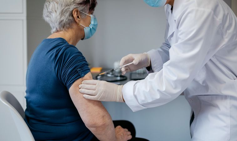 Older woman being vaccinated against coronavirus