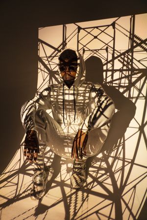 Black man dancing under bright light