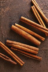 Cinnamon sticks on brown background