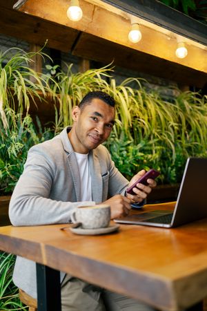 Man working on laptop at cafeteria