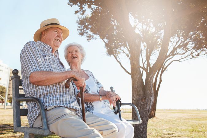 Relaxed mature couple sitting on a park bench