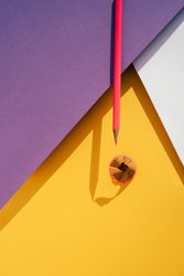 Back to school: Pink pencil on geometric background
