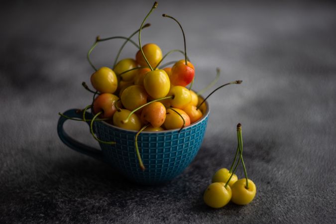Cherries in blue mug