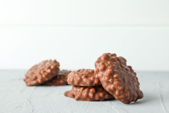 Chocolate cookies on grey table against light background, space for text