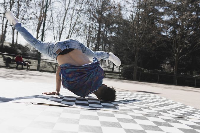 Man dancing break dance in park