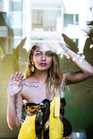 stylish woman looking through window