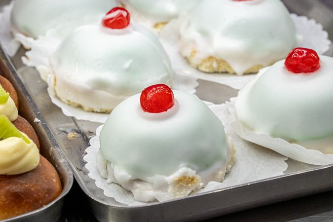 Traditional mini Sicilian cassata dessert topped candied cherry icing sweet italian pastry