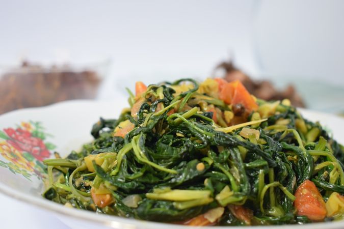 Plate of healthy cooked spinach side dish on table
