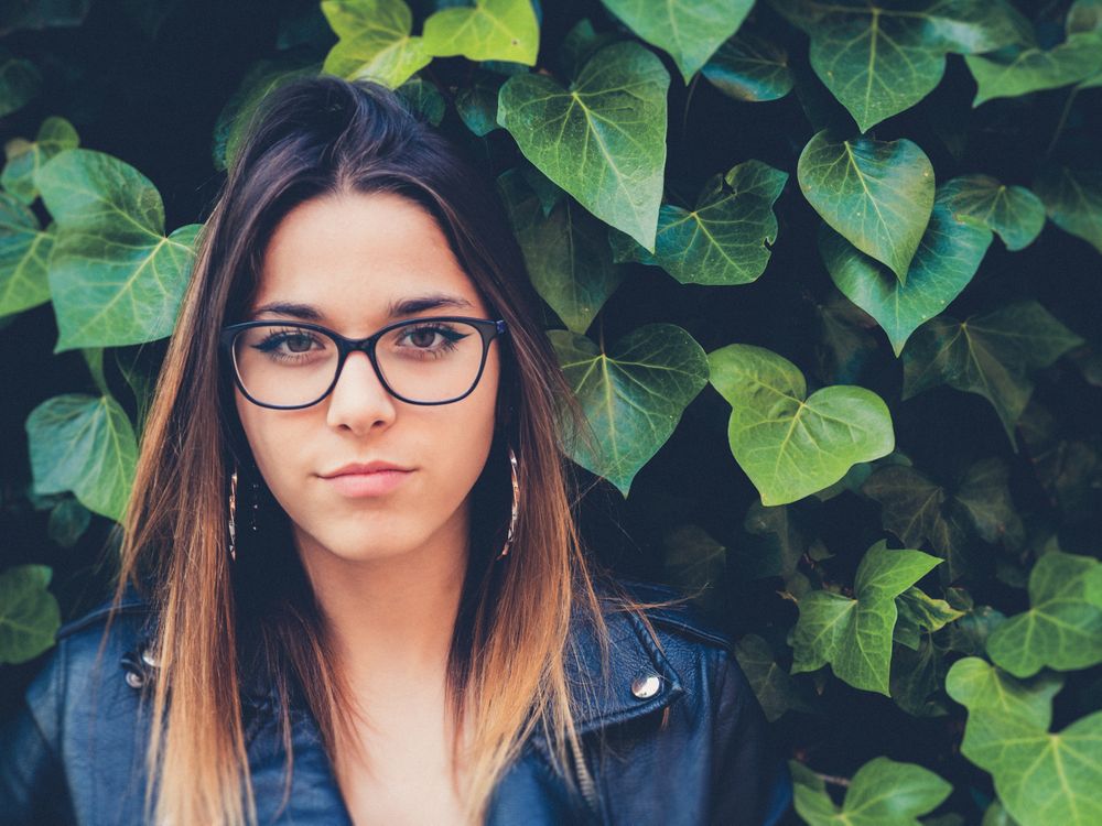 Woman in front of bush
