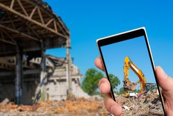 Person taking photo of excavator