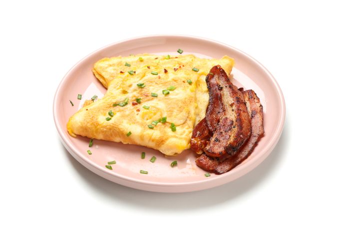 Pink plate with omelette and bacon