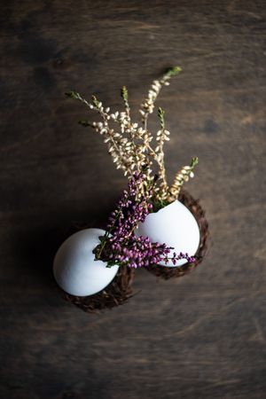 Heather in decorative eggs on wooden table with copy space