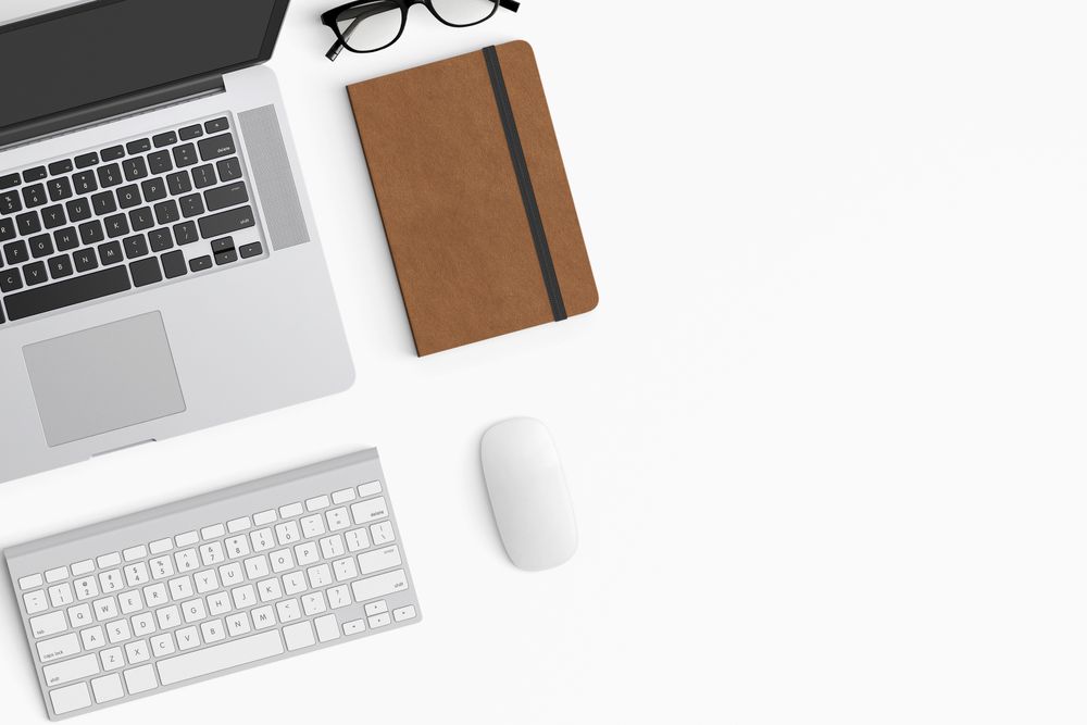 Modern workspace with coffee cup, smartphone, paper, notebook, tablet and laptop
