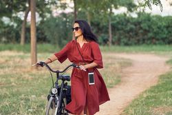 Young woman with bicycle in park
