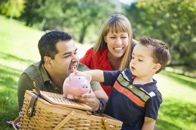 Couple Give Their Son a Piggy Bank at the Park